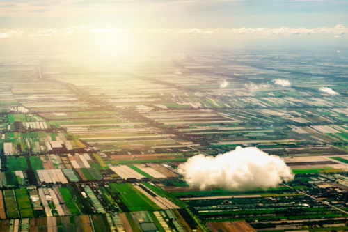 Cloud in front of green landscape
