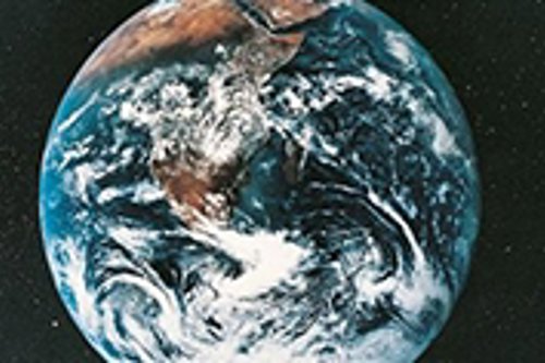 View of Earth from space with North and South America visible, surrounded by the blackness of outer space, representing global beauty and environmental awareness