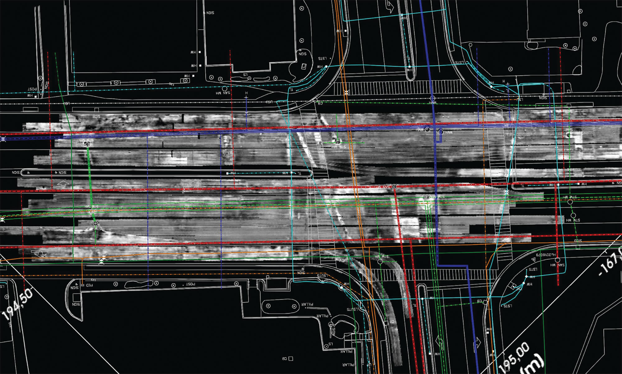 Aerial view of a roadway construction or engineering plan with overlapping colored lines, lane markings, and technical diagram details on a dark background.