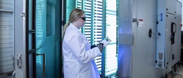 Kiwa PVEL employee standing in front of a backsheet testing set up
